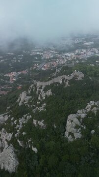 Aerial drone view around Pena Palace, Moorish castle and Village Palace from ex Portuguese monarchy. Sintra town, Lisbon, Portugal