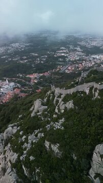 Aerial drone view around Pena Palace, Moorish castle and Village Palace from ex Portuguese monarchy. Sintra town, Lisbon, Portugal