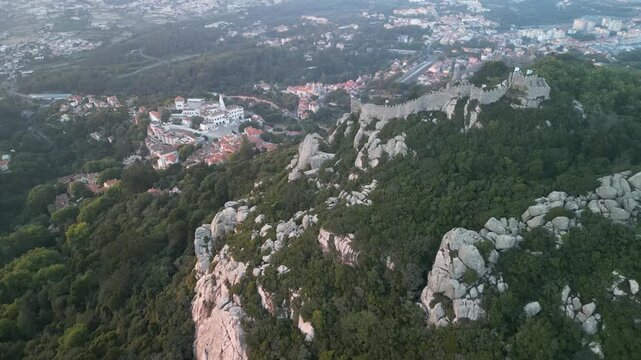 Aerial drone view around Pena Palace, Moorish castle and Village Palace from ex Portuguese monarchy. Sintra town, Lisbon, Portugal