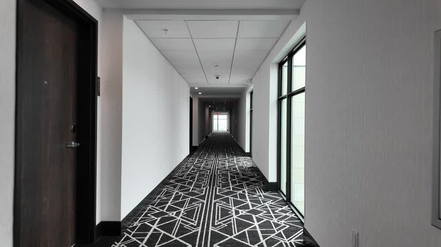 Walking Down a Long Hotel Corridor With Doors on Each Side