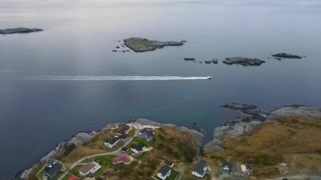 Aerial footage of a ship sailing along the coast of Lofoten, Norway, on a cloudy day, drone footage, 4k 30fps