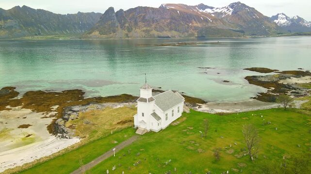 Aerial images of Iglesia de Gims&oslash;y (Gims&oslash;y kirke) in Lofoten, Norway, during a sunny day, 4k 30 fps, drone video