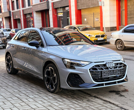 A nardo gray 
Audi A3 Sportback 35 TFSI IV (8Y) parked on street, luxury car exterior. The modern exterior of a premium Germany sportback hatchback car Audi A3 gray color. VAG Group. 