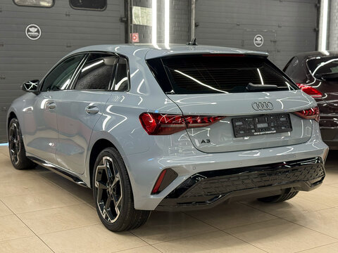 A nardo gray Audi A3 Sportback 35 TFSI IV (8Y) in showroom, luxury car exterior. The modern exterior of a premium Germany sportback hatchback car Audi A3 gray color. VAG Group. 