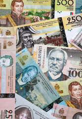 Fototapeta premium Haitian gourde money banknotes pile on table. Haiti bills of HTG currency. Concept of economy