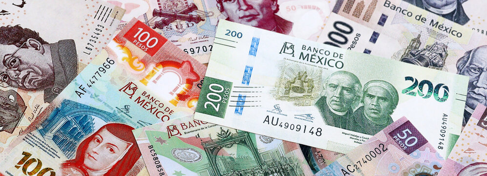 Mexican peso money banknotes pile on table. Mexico bills of MXN currency close up