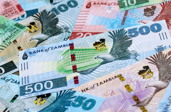 Zambian kwacha money banknotes pile on table. Zambia bills of ZMW currency close up