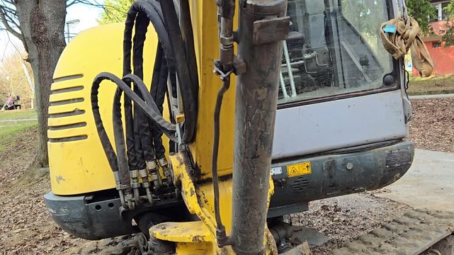 Mini excavator parked on a construction site, close-up.