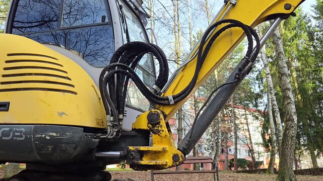 Mini excavator parked on a construction site, close-up.