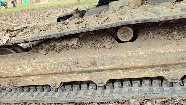 Dirty caterpillar tracks of construction machinery on soil.