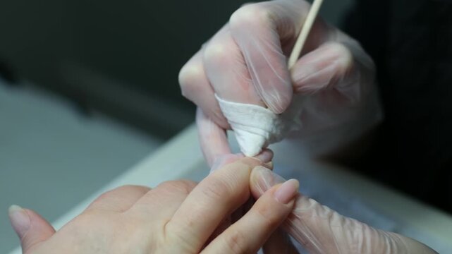 nail master applying gel polish, step by step guide.manicurist is using a nail file,drill, first,remove cuticle with nipper and push with stick.woman buffing,clean,degrease and using uv lamp. 4k