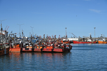 Fototapeta premium fishing boats in port, construction site with crane
