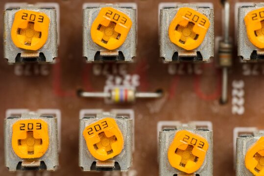 Macro Top View of Orange Trimmer Potentiometers on a Circuit Board