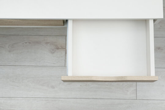 Desk with open empty drawer indoors, top view