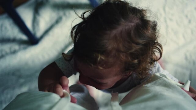POV of parent looking down at crying toddler reaching upward with arms, capturing demand for attention, emotional expression, and intense childhood moment in home environment