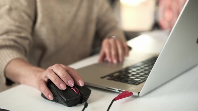 Girl Working On A Laptop Using A Mouse On A Table In The Living Room