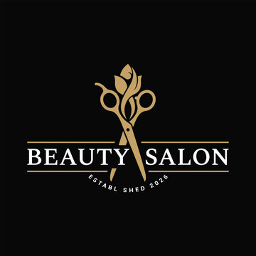 Beauty salon logo with gold scissors and text