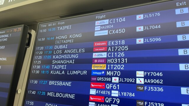 Narita International Airport flight arrival board at Hot Heart facility showing international schedules for Emirates, Qantas, and China Airlines - Chiba, Japan, October 29, 2025