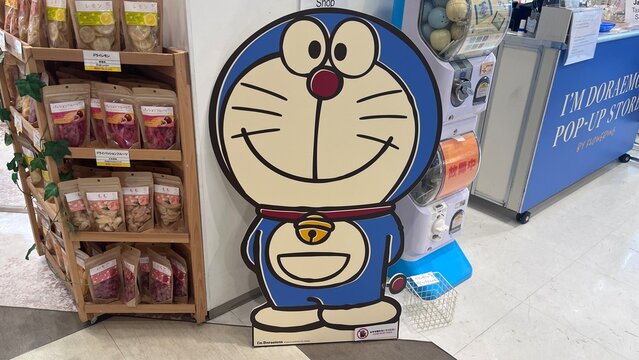 Doraemon life-size character cutout at the I'm Doraemon Pop-up Store by Flowering featuring Gachapon machines and snacks at Narita Airport - Chiba, Japan, October 29, 2025