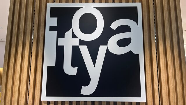 Itoya stationery store corporate logo and brand signage on a modern decorative vertical wood slat wall at Narita International Airport - Chiba, Japan, October 29, 2025