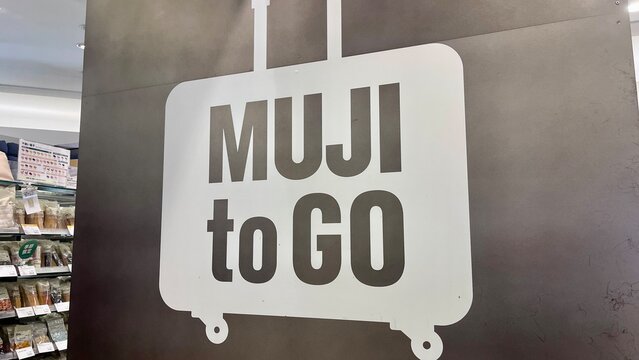 MUJI to GO store signage featuring suitcase graphic at Narita International Airport (NRT) specialized retail outlet for travel essentials - Chiba, Japan, October 29, 2025