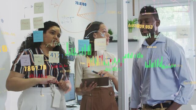 Team planning at glass wall, center tapping tablet initiating finance charts and prioritizing notes