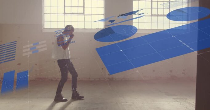 Man adjusting headset walking across loft as blue graphics sliding in, engaging gestures for tech