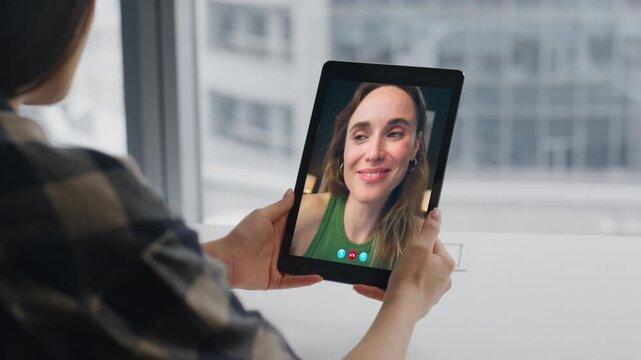 Woman hands calling tablet screen virtual conference in city view flat closeup
