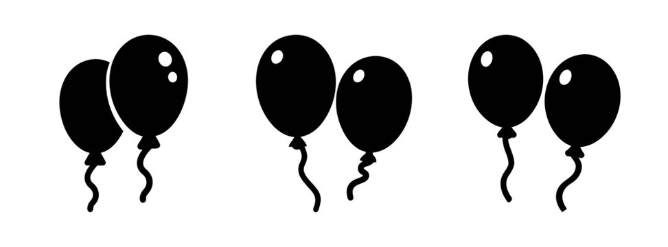 Black balloons on strings floating in air