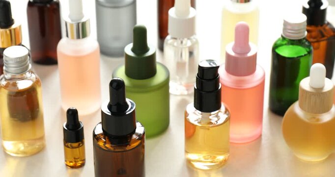 Different cosmetic products on white table, closeup. Camera moving right