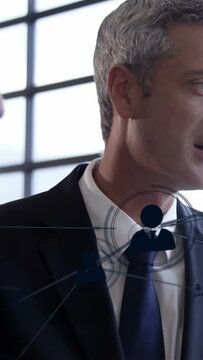 Vertical video: Lens shifting to exec, icons sliding across face, turning, smiling, mapping data