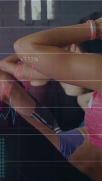 Vertical video: Group doing crunches in gym, overlay charts rising with reps tracking effort