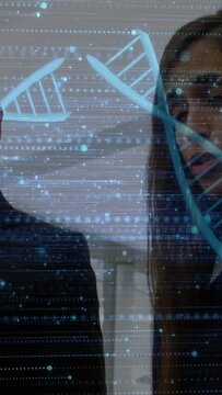 Vertical video: Woman speaking and causing DNA helix to split across both faces during biotech talk