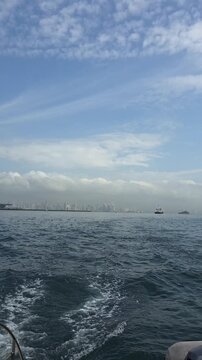 Cityscape of Panama City, Panama and boats in the harbor. Vertical video.