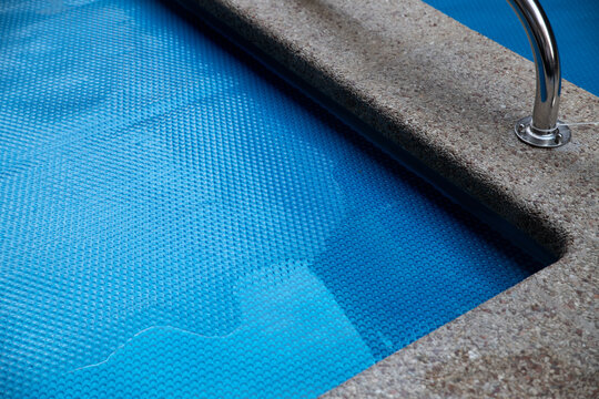 The surface of the pool is covered with a protective coating. Winter season and pool maintenance, pool protection. Selective focus.