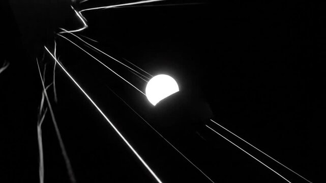 Abstract geometric shapes and bright light trails rotating in a dark black space digital animation