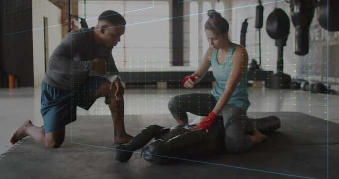 Trainer coaching trainee pressing dummy chest for fitness, HUD evolving over scene giving feedback