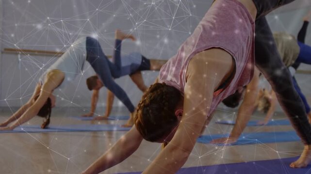 Coach cueing front woman holding down dog while yoga class lifting leg for balance, digital overlay
