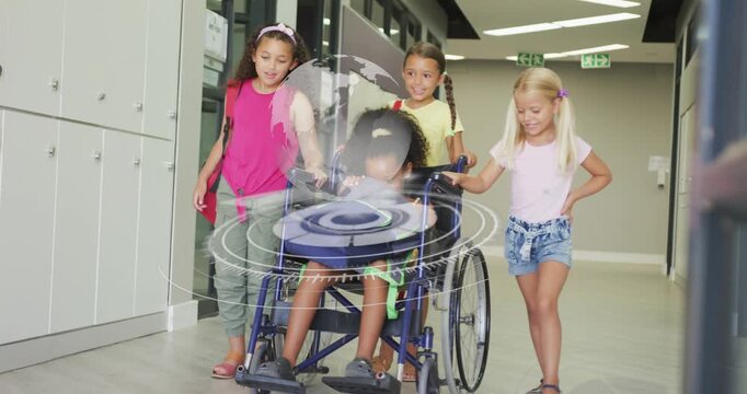 Vertical video: Four girls pushing wheelchair along hall, activating AR globe on chair in education
