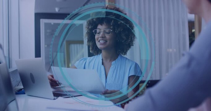 Woman glancing at laptop causing cyber overlay while presenting, rings expanding around her