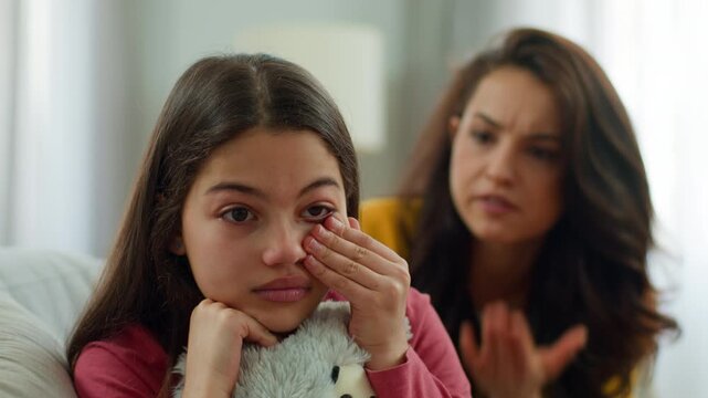 Angry Caucasian mother mom shouting family quarrel sad little girl sister crying mad woman female yelling parent arguing fighting kid daughter cry hug toy indoor bad relationship child abuse at home