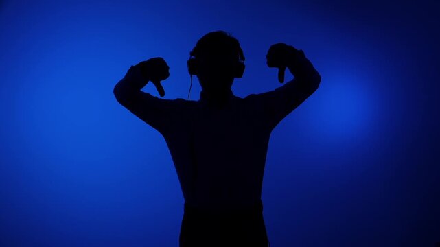 Silhouette of a person wearing headphones on a vibrant blue background, expressing strong disapproval and rejection with both hands giving a thumbs down gesture