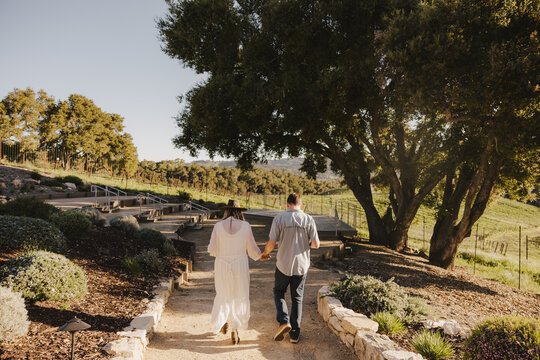 Couple Walking Towards Vineyard