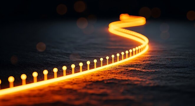 Glowing orange light path on a dark textured surface creates a guiding trail for success and innovation during the night with a warm bokeh glow