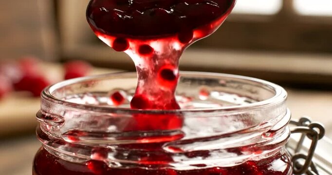 Red jam in a glass jar.