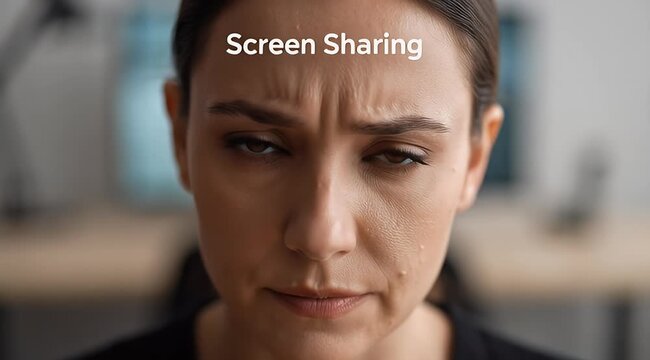 Stressed Woman Concentrating on Screen Sharing During Virtual Meeting; Close-up of Frustrated Professional Facing Technical Difficulties