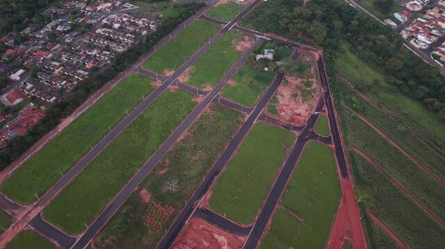 An aerial view of a meticulously planned residential community with empty lots ready for construction.