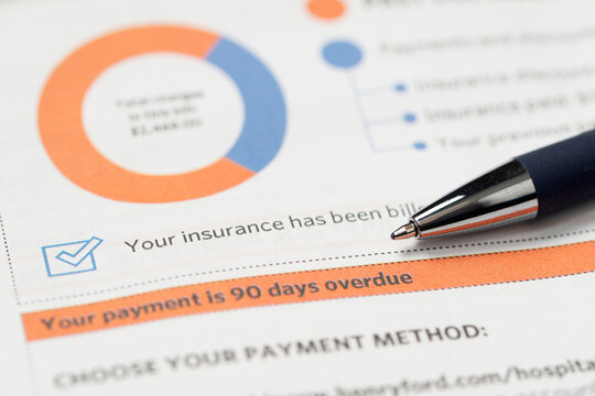 Medical billing statement showing a past due amount, with a pen placed on top. Highlights financial stress, healthcare costs, insurance adjustments, and overdue payments.