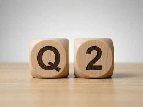 q2 text on wooden blocks placed on clean surface with minimal background for business and financial quarter concept