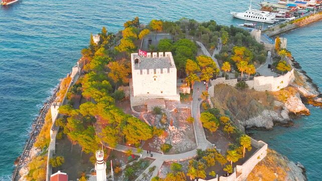 Kusadasi, Turkey. Close up view of the main tower and flag at Kusadasi Castle on Pigeon Island at sunset. Detailed shot of the ancient fortress in golden light.. Aerial View, MasterShots, Zoom In, Ci